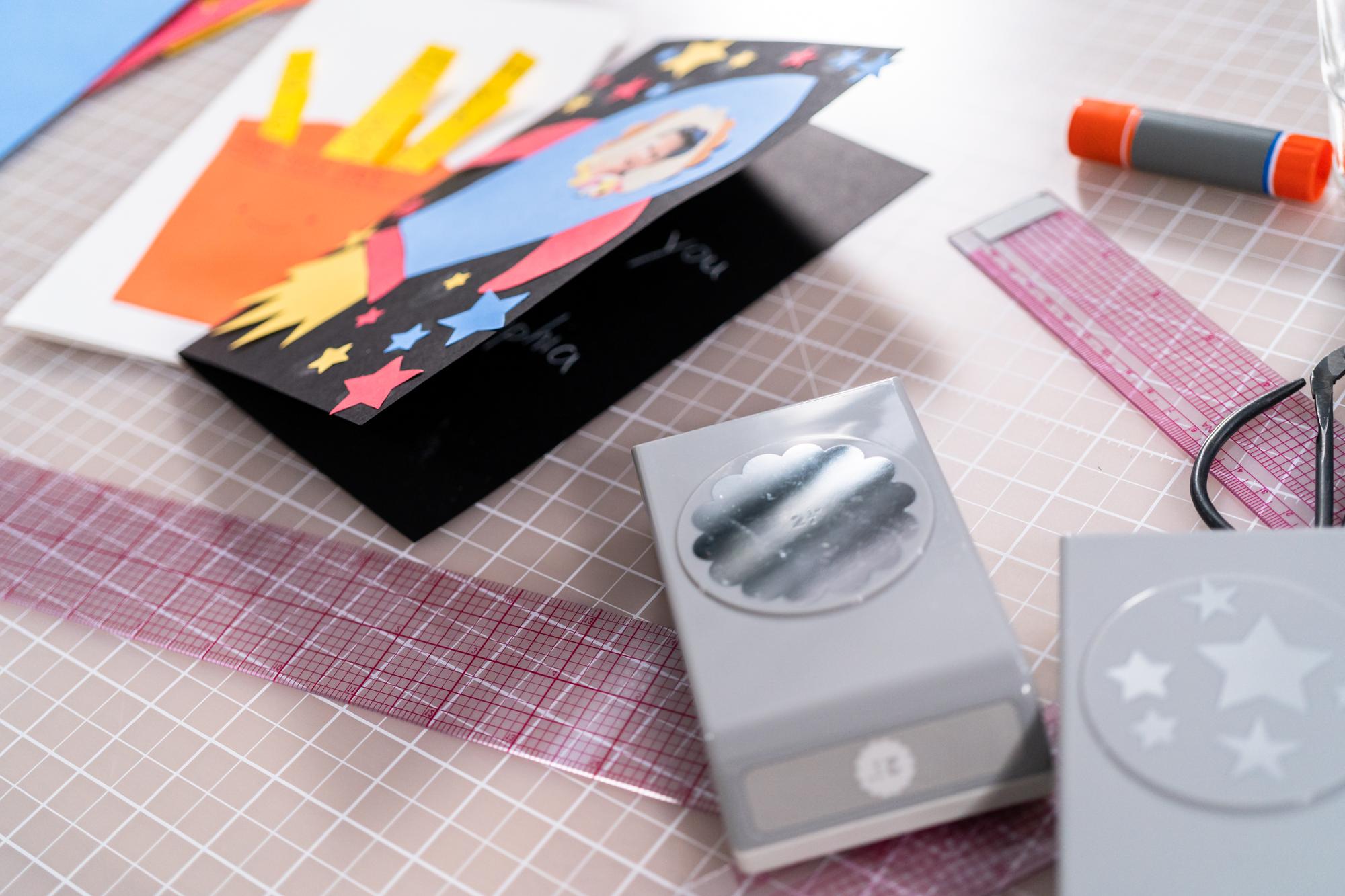 Studio workbench with threads, hoops and digital pattern tablet
