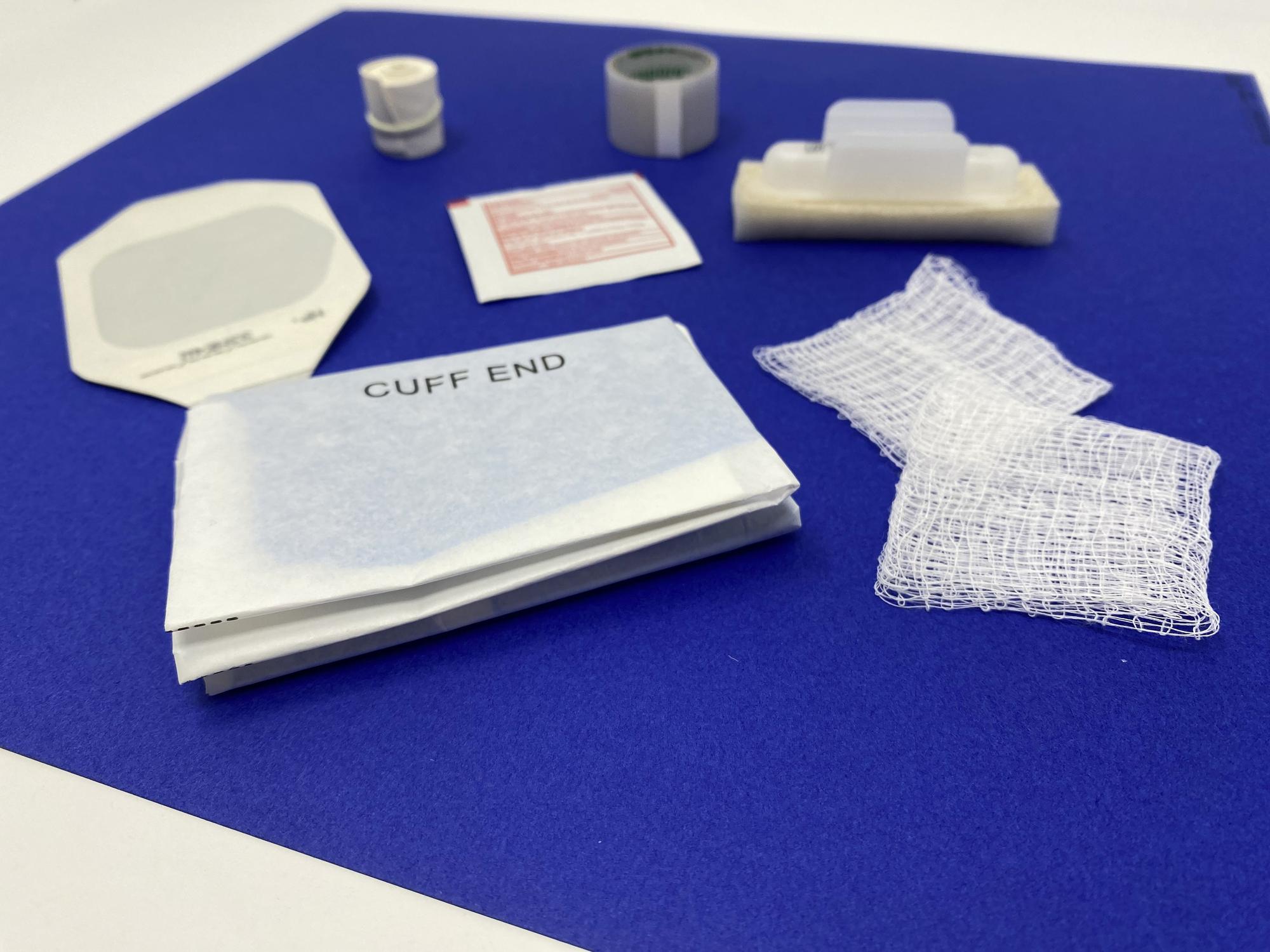 Packaging and finished embroidered samples on table